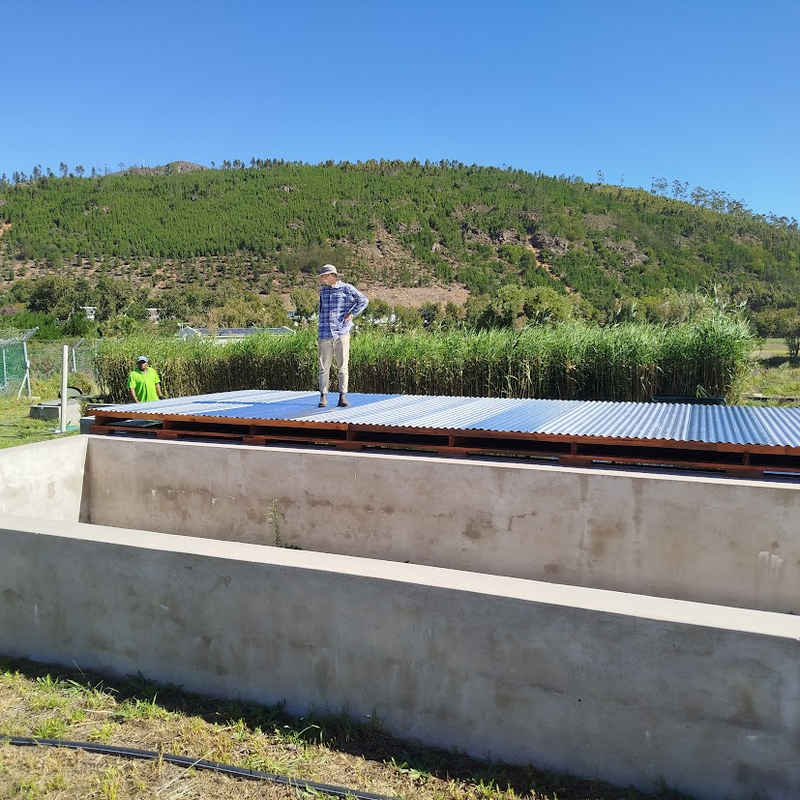 Construction of the cover over the irrigation dam with Dr Anthony Fry and Mr Simphiwe Madyibi